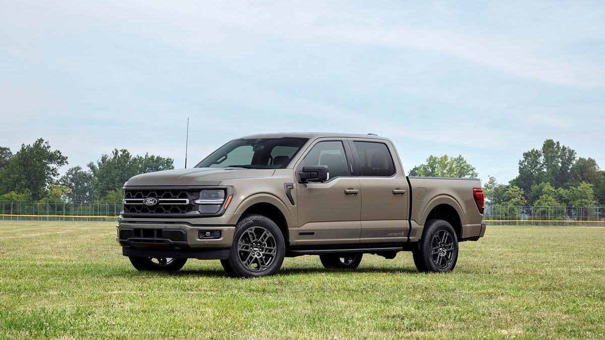 Tan Ford F-150 SuperCrew pickup parked on a grass field, front three-quarter view